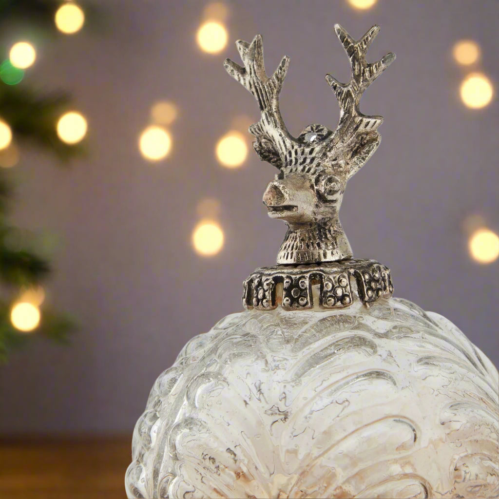 Decorative glass christmas hanging bauble. ombre colouring and with a stag head as a topper.
