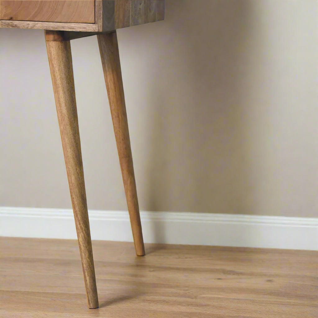 Cut-out natural dressing table, with oak-ish finish displaying close up of right nordic style legs