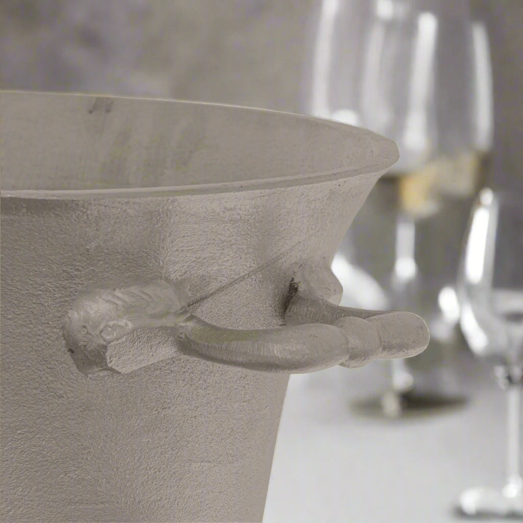 Close-up of the handle of a silver pewter champagne bucket