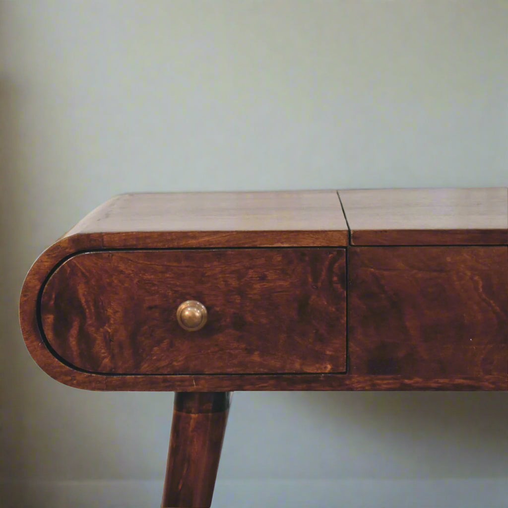 Rounded dressing table, with california walnut finish, showcasing close up view of left rounded corner and drawer.