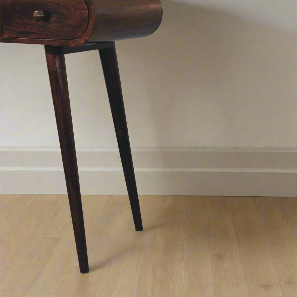 Rounded dressing table, with california walnut finish, displaying close up of left nordic style legs