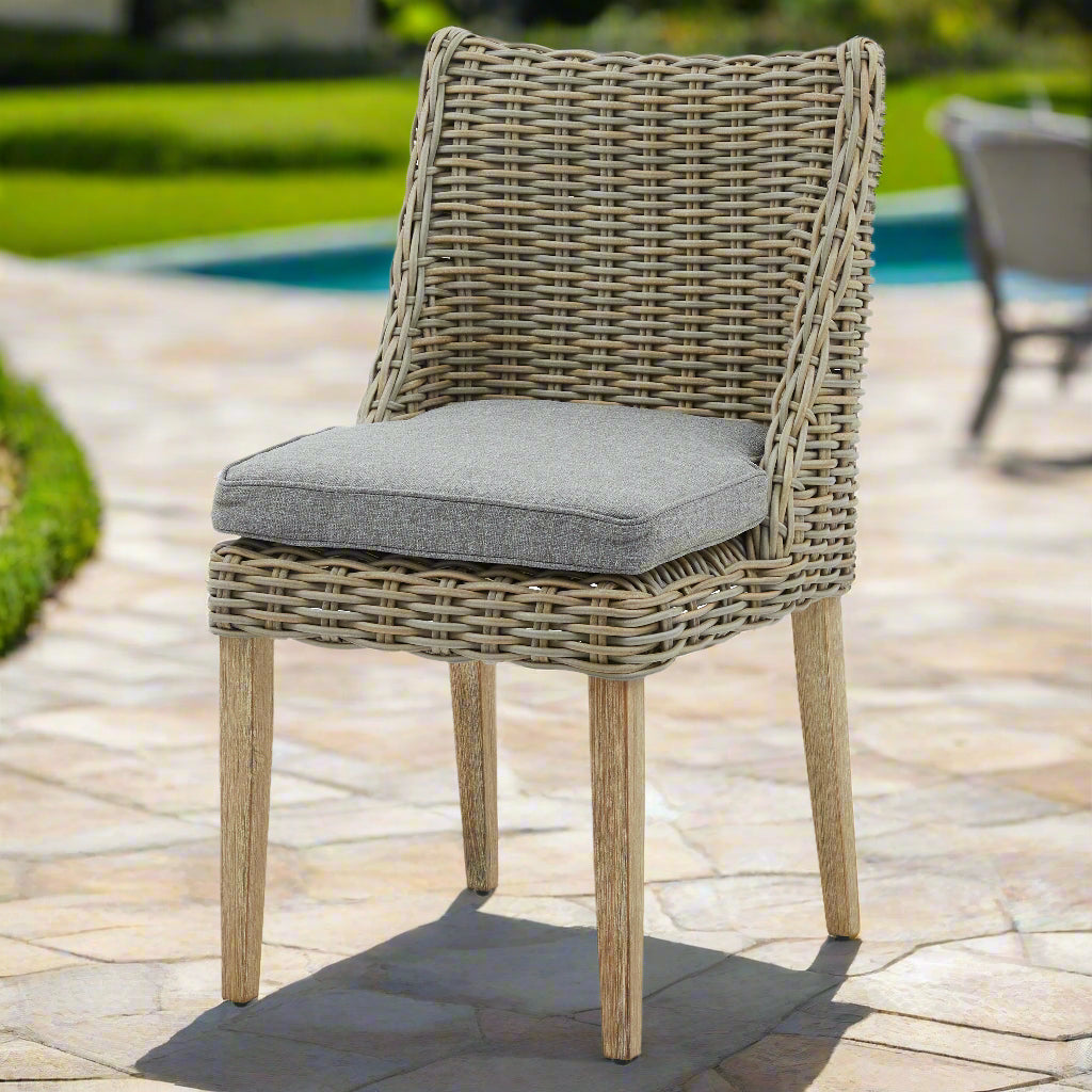 Front view of the Amalfi Round Dining Chair, showing a well-woven wicker, comfortable cushion, and sturdy feet.