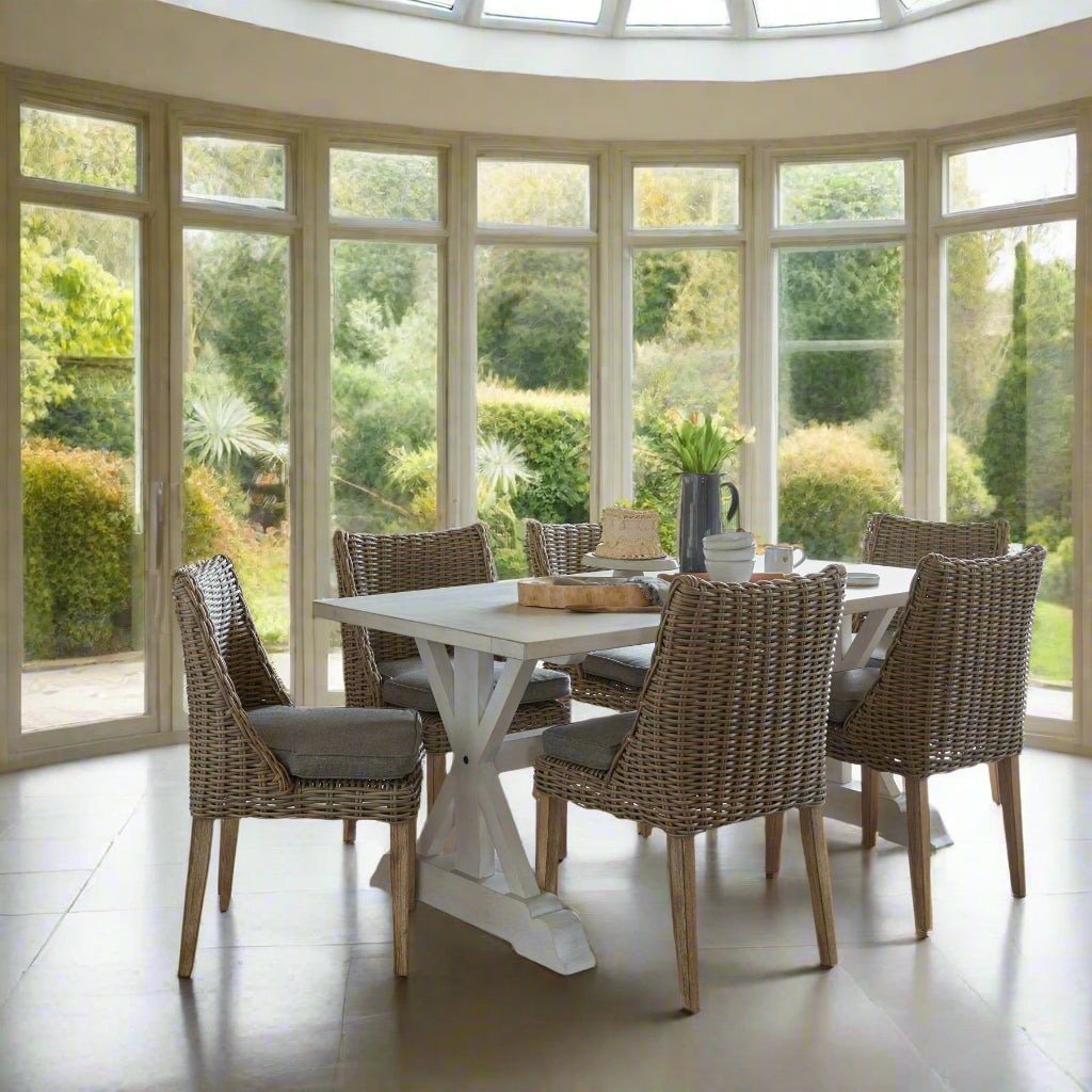 Side view of a set of 6 Amalfi Round Dining Chairs set up around a dining table.