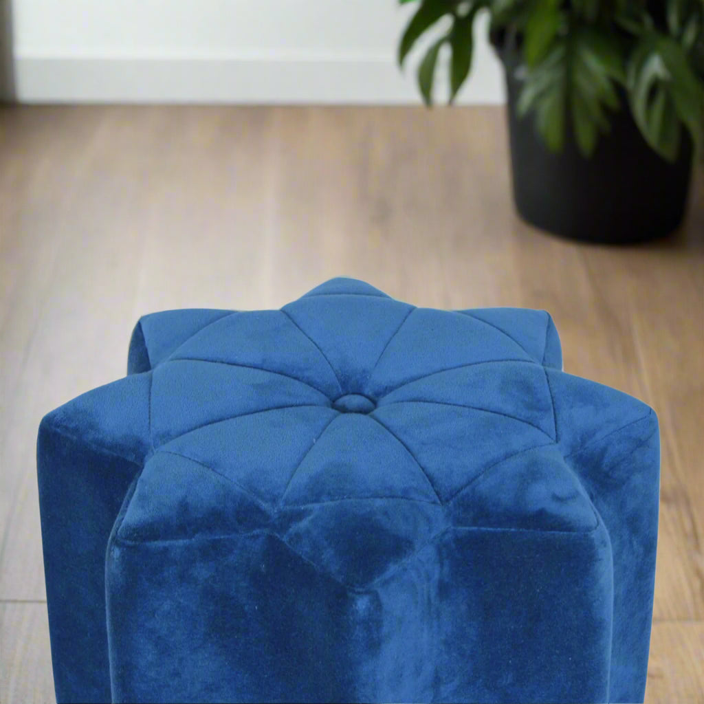 Angled view of the blue velvet star footstool, showcasing its unique multi-pointed shape and soft fabric upholstery.