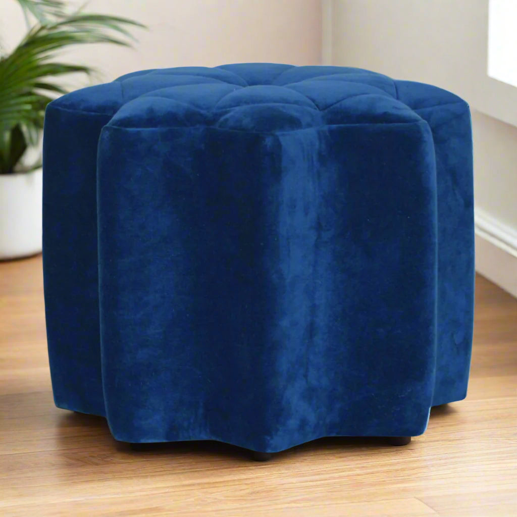 A vibrant blue velvet star-shaped footstool with a deep buttoned top, a unique accent piece perfect for modern living rooms or bedrooms.