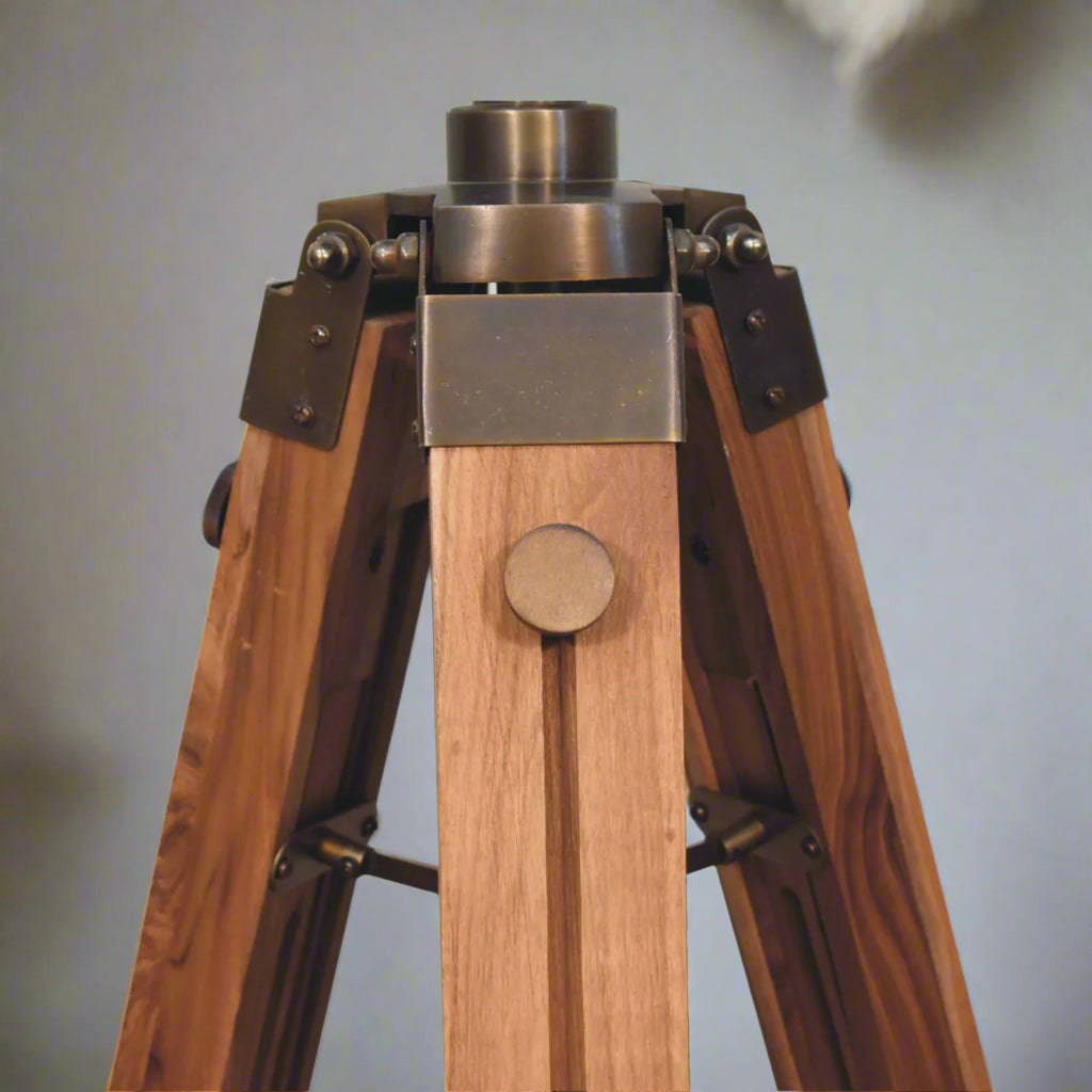 Close-up shot of the point where the tripod stand is attached to the Brass Caged Spotlight Floor Lamp, with the lamp detached.