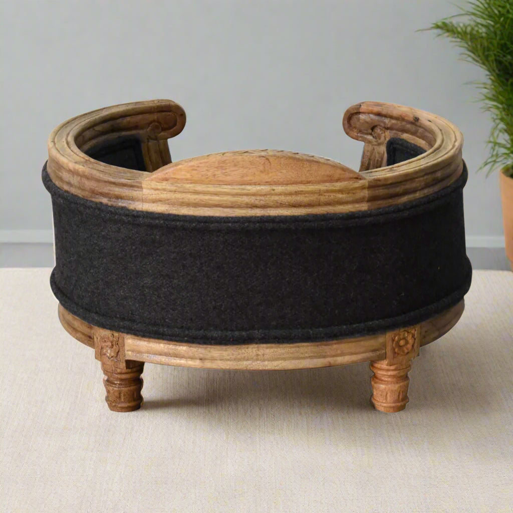 Rear view of the elevated pet bed, highlighting the curved wooden back and supportive cushioned seat in deep grey tweed.