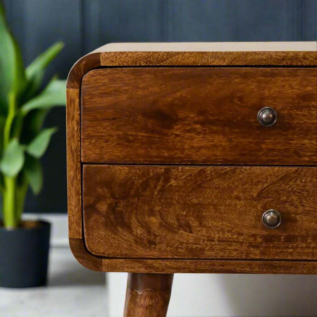 Close-up of the two drawers on the curved chestnut bedside table, highlighting the natural wood grain and simple knob handles.
