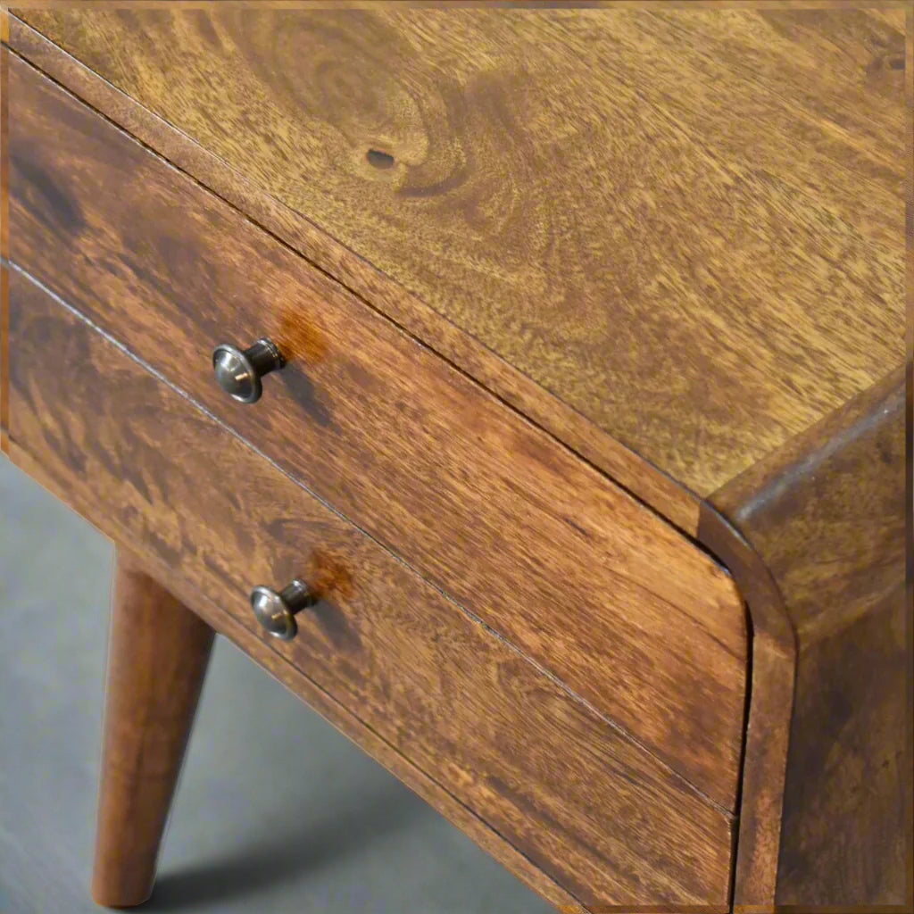 Detailed close-up of the rounded top corner of the curved chestnut bedside table, showing the smooth finish.