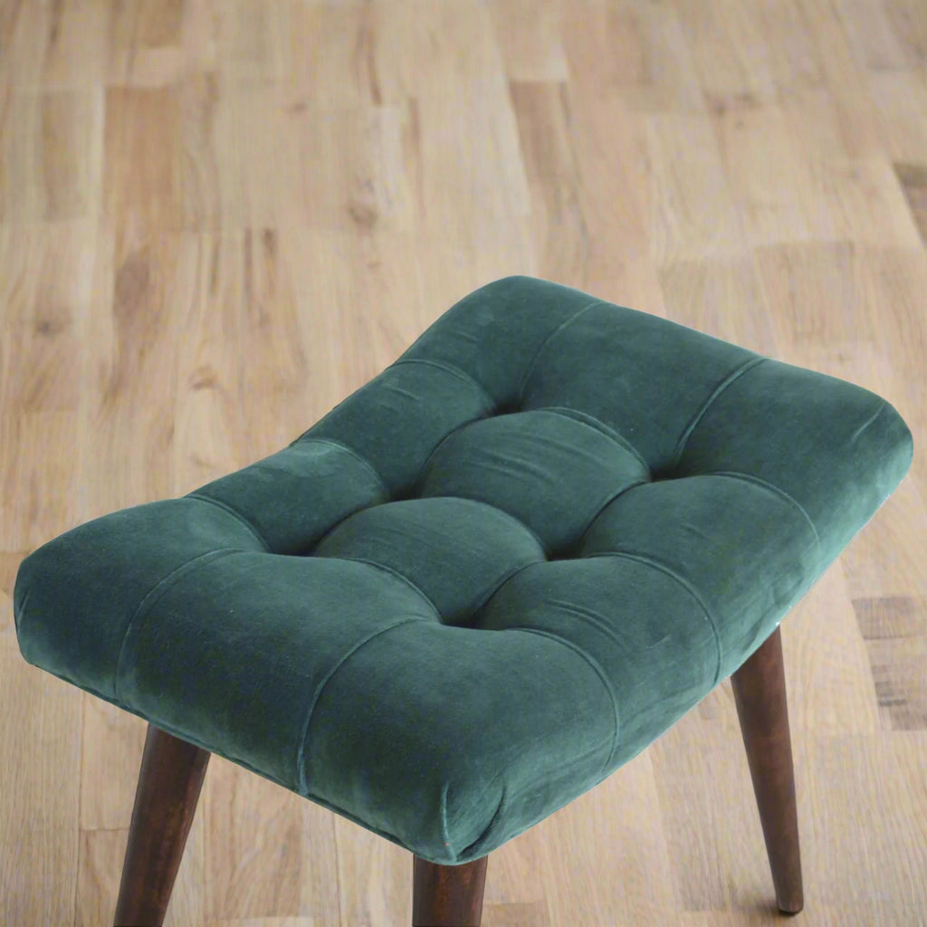 Top‑down view highlighting plush seat and partial legs on a wooden floor