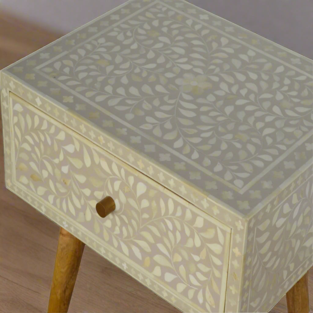 Elevated shot from the left side of the Floral Bone Inlay 1 Drawer Bedside Table in grey, showing its upper surface, front surface, and a section of the legs.