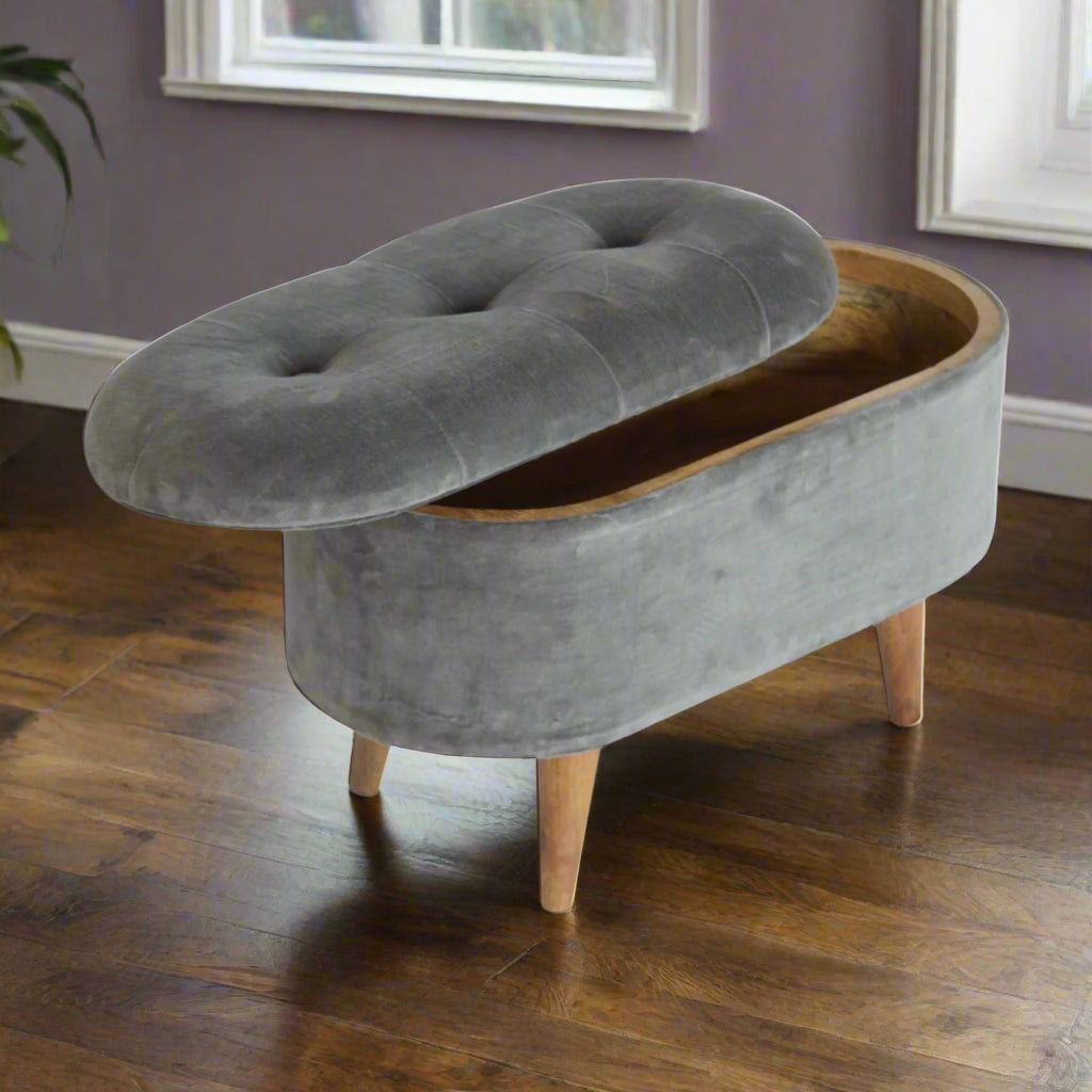 Elevated angled view of the Grey Velvet Storage Footstool, showing its storage compartment slightly opened and the deep button upholstery.