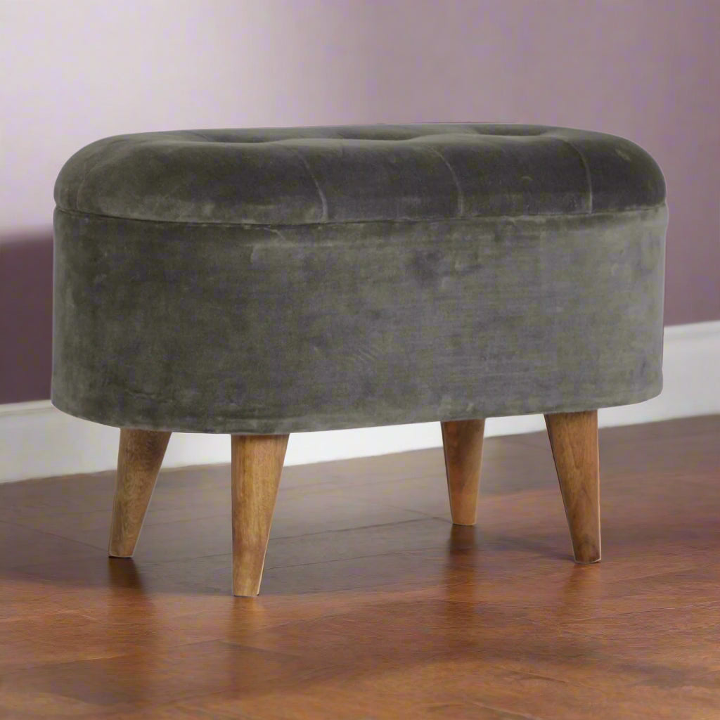 Eye level angled view of the Grey Velvet Storage Footstool, highlighting its curved design and velvet fabric.