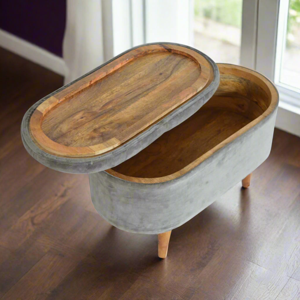 Top-down view of the Grey Velvet Storage Footstool, with the storage compartment cover placed upside down, revealing the interior storage.