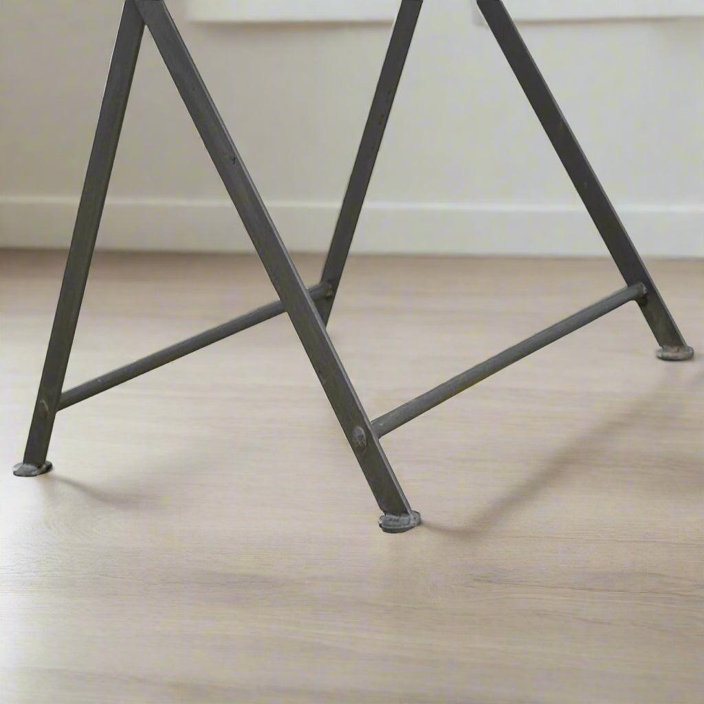 Zoomed-in view of the cross iron base, showing sturdy construction and foldable practicality.