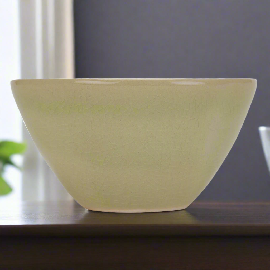 Eye-level view showing the vase's light green ceramic finish.
