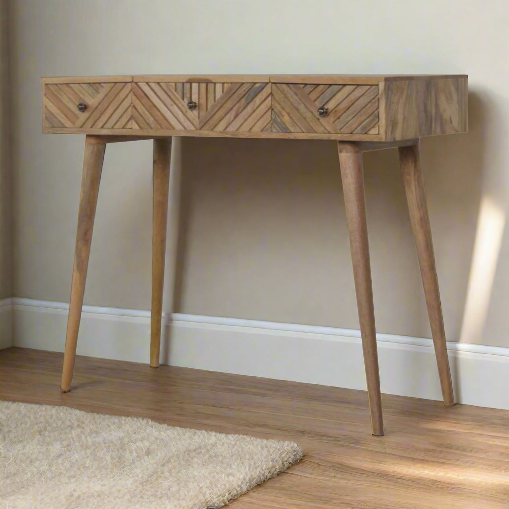 Angled front view of the line carved dressing table, showing closed drawers and mirror.