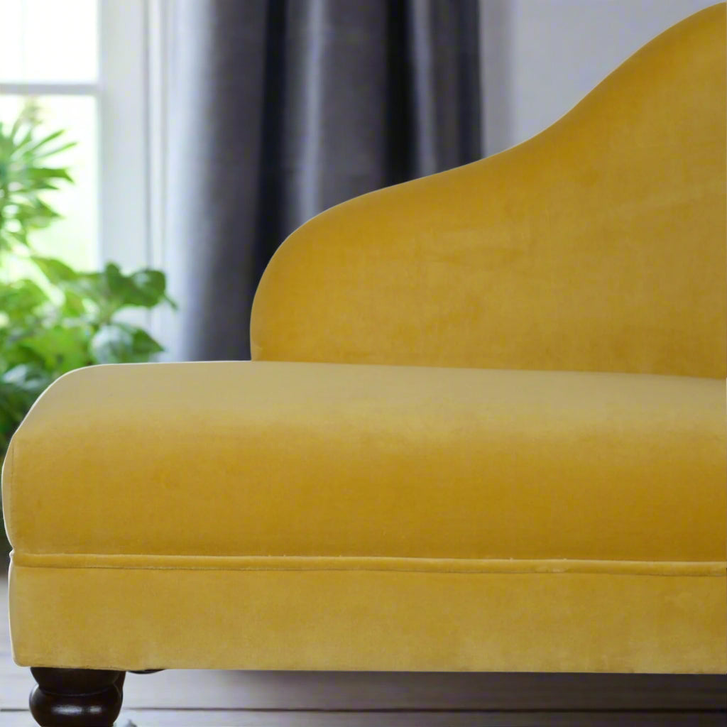 Close-up view of the padded seat of the mustard velvet chaise, showing the luxurious texture of the yellow cotton velvet in detail.