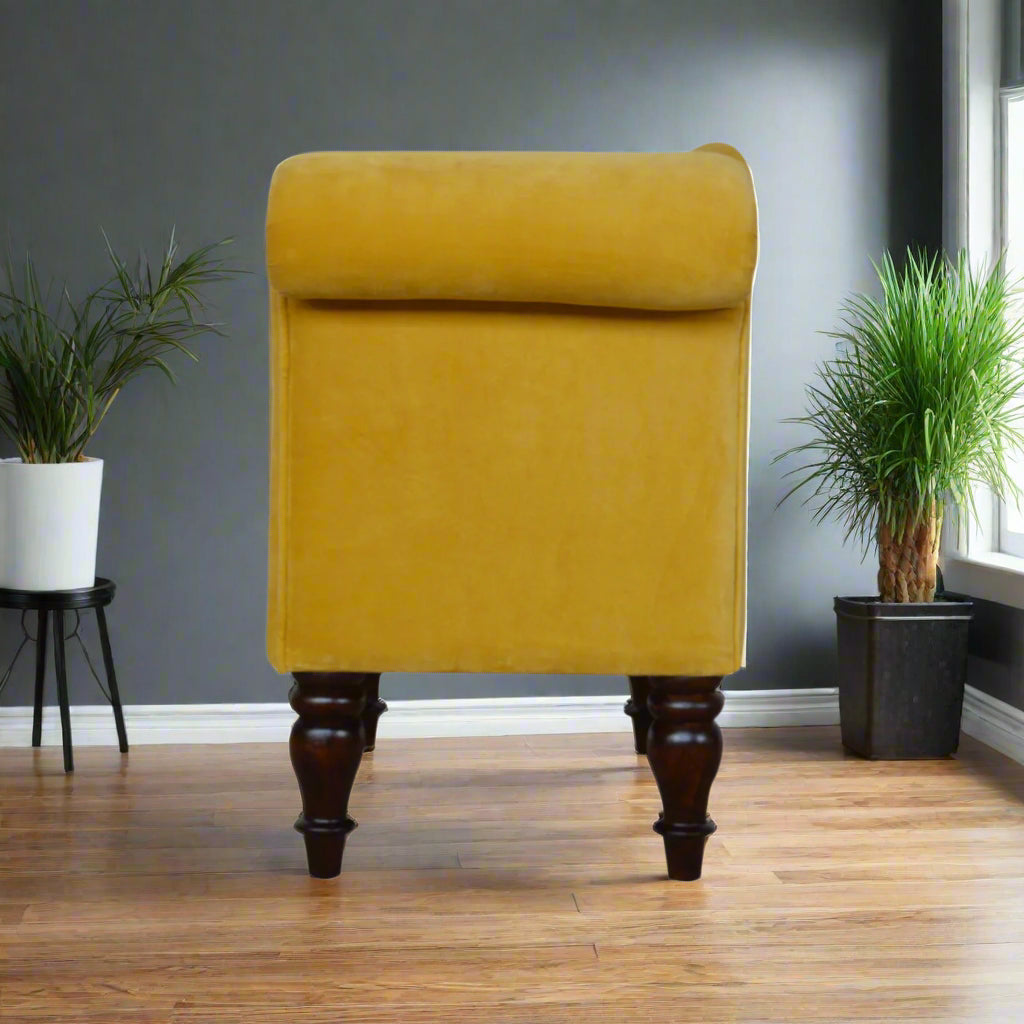Full side view of the mustard velvet chaise, displaying its elegant profile and design.