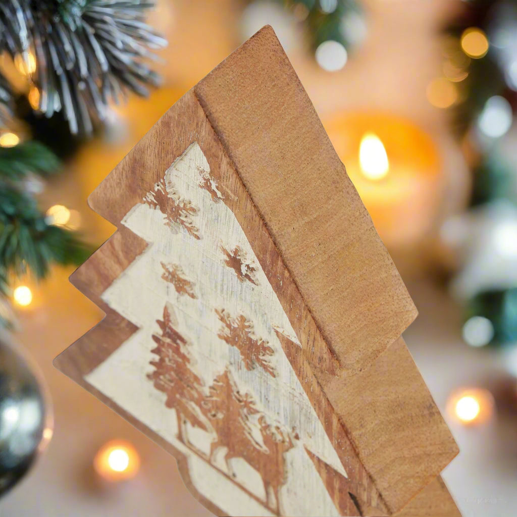 Angled view of a natural wooden snow scene tree decoration, highlighting the layered design and depth of the winter forest imagery.