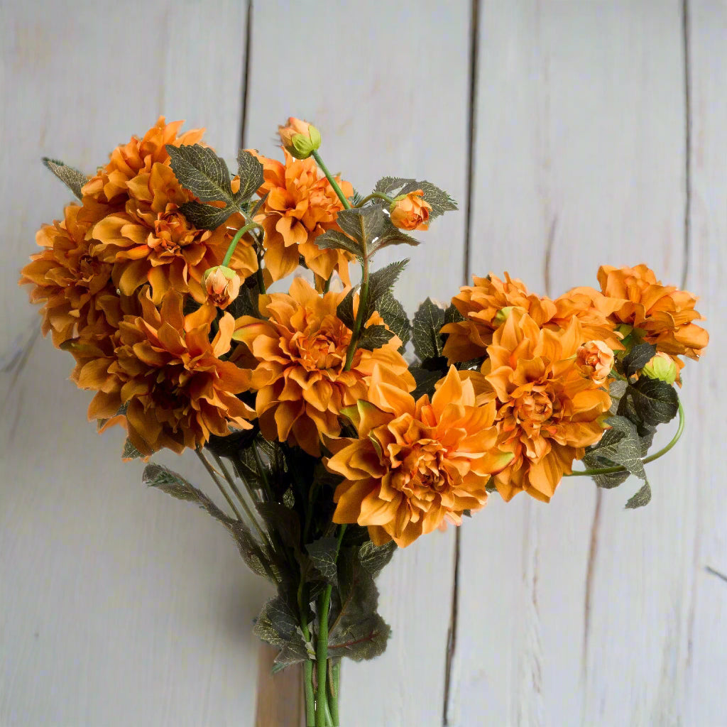 Bunched orange dahlia stems perfect for creating autumn bouquets.