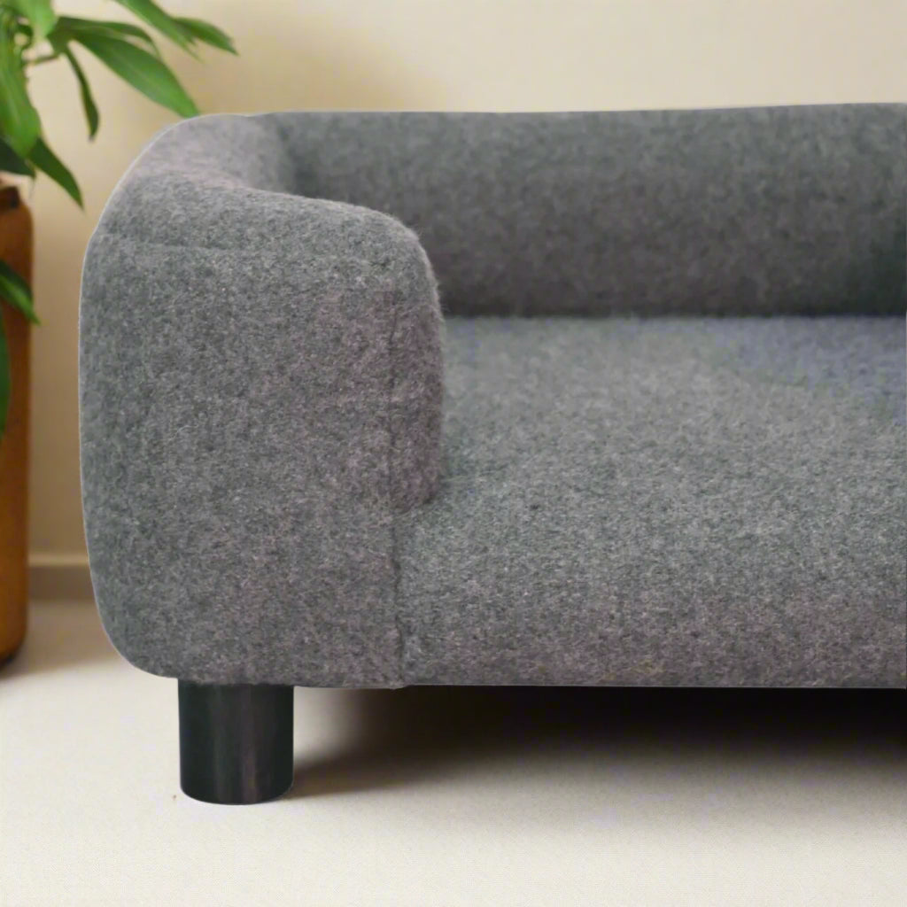 Focused side view of the right armrest and cushion of the mini sofa bed.