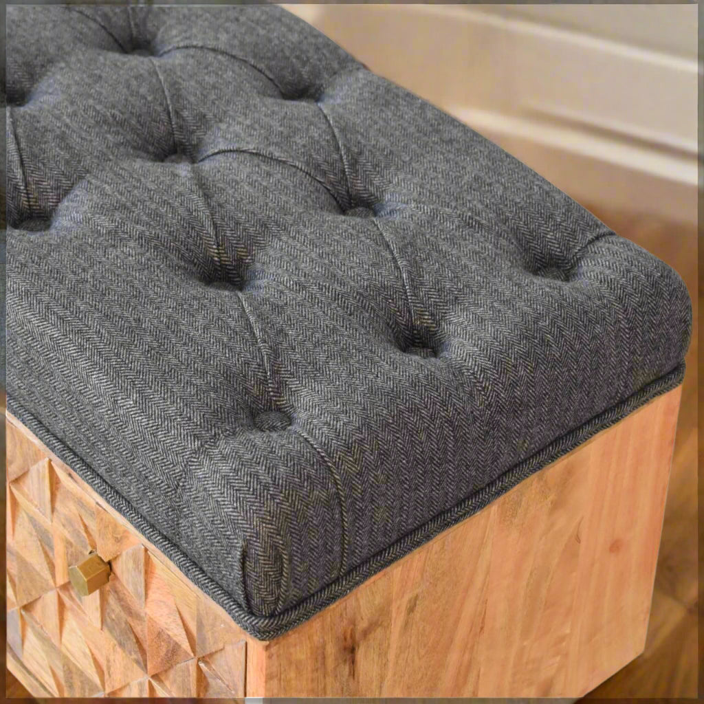 Detailed close-up of grey tweed upholstery on bench seat.