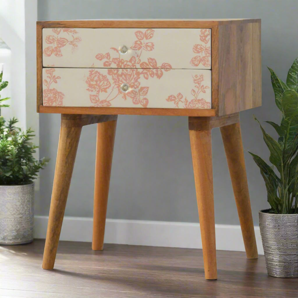 Angled view of bedside table with pink floral screen-printed drawers and four Nordic-style legs in oak-ish finish – Purple Flamingo UK