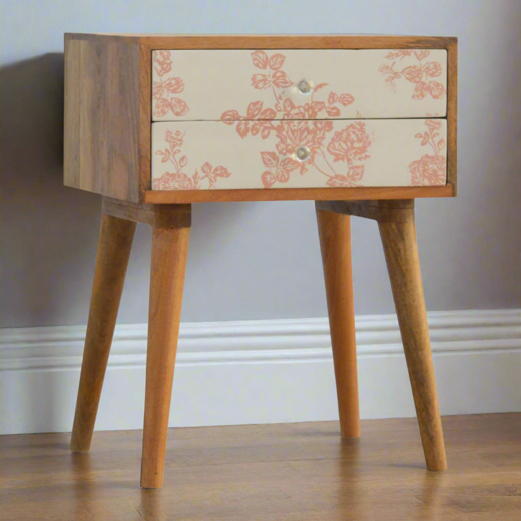 Front view of bedside table with oak-ish finish and two pink floral screen-printed drawers on Nordic-style legs – Purple Flamingo UK
