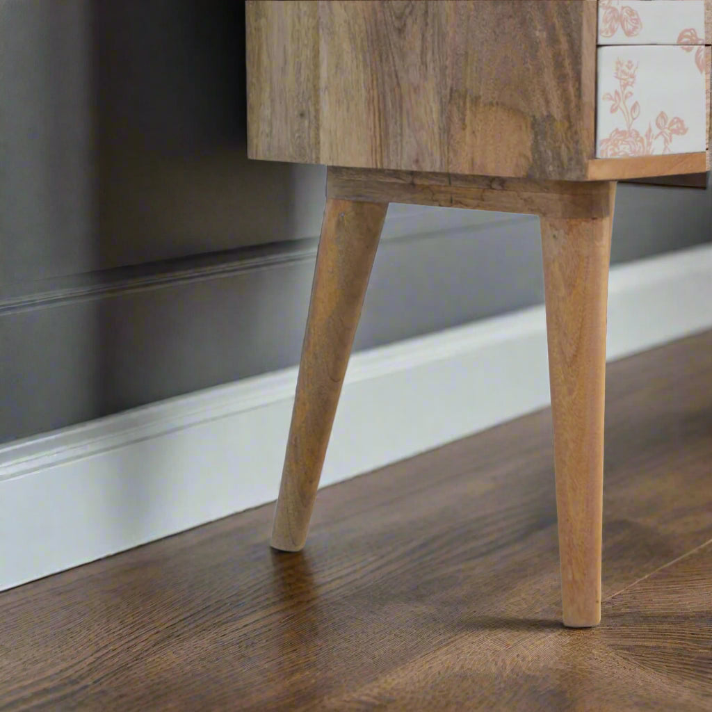 Close-up of the legs of the oak-ish finish mango wood bedside table, showing natural wood grain and finish – Purple Flamingo UK