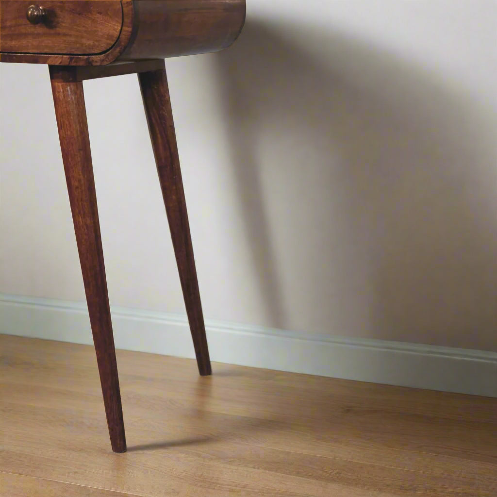 A close-up view of the rounded dressing table with honey caramel finish, showcasing the Nordic style legs.