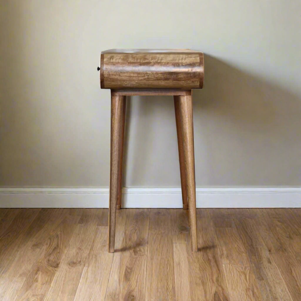 Side view of the rounded dressing table, with oak-ish finish, displaying smooth rounded table top outline