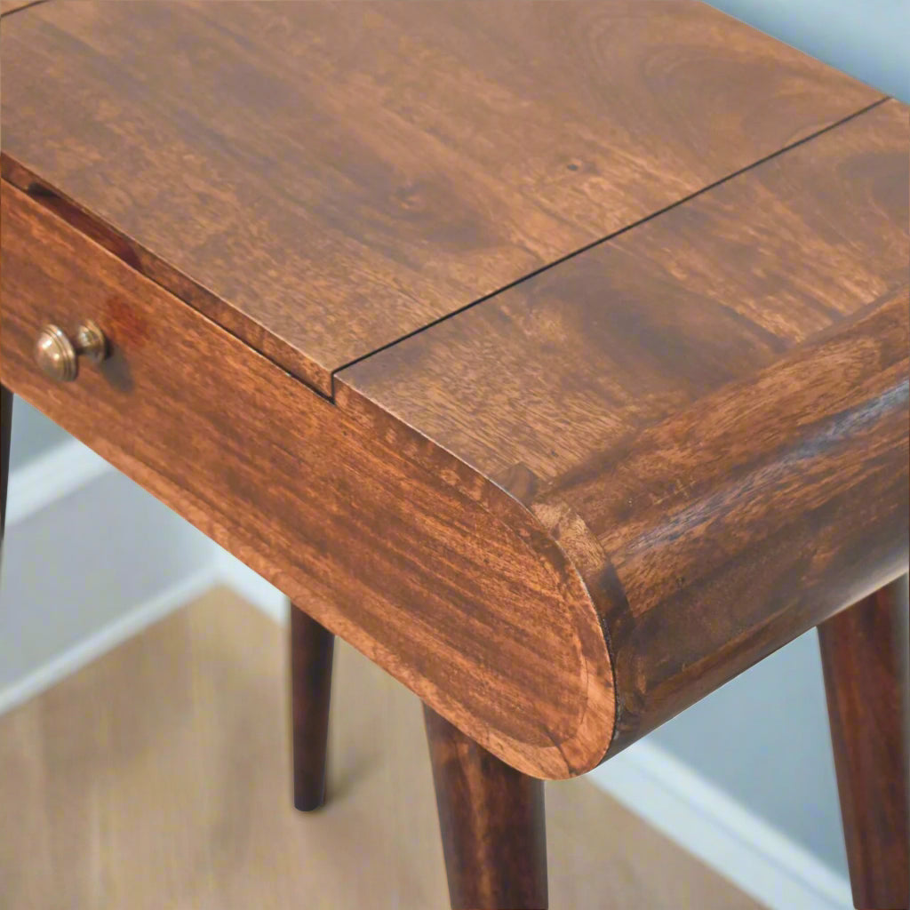 Rounded mini dressing table with california walnut finish, close up top view of rounded corner and close fold-up mirror.