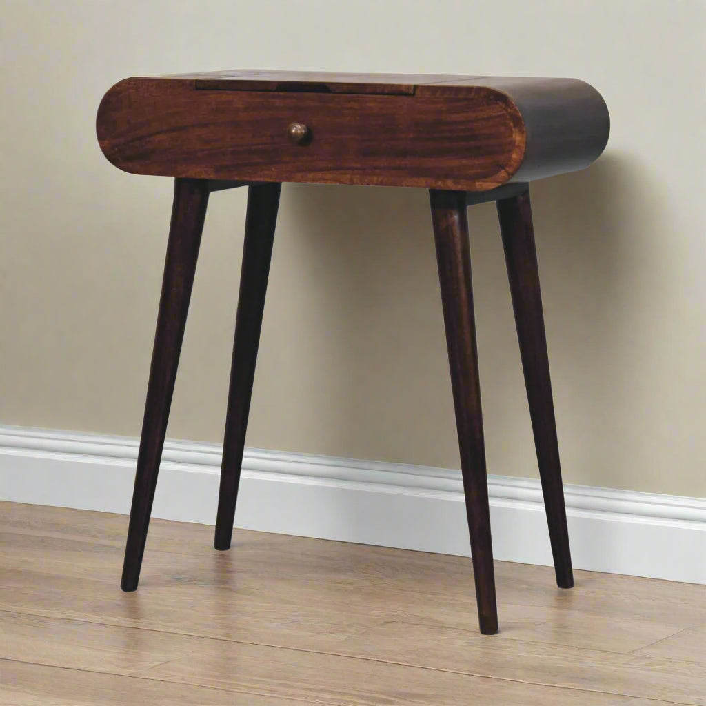 rounded mini dressing table with california walnut finish, displaying nordic style legs and closed drawer.