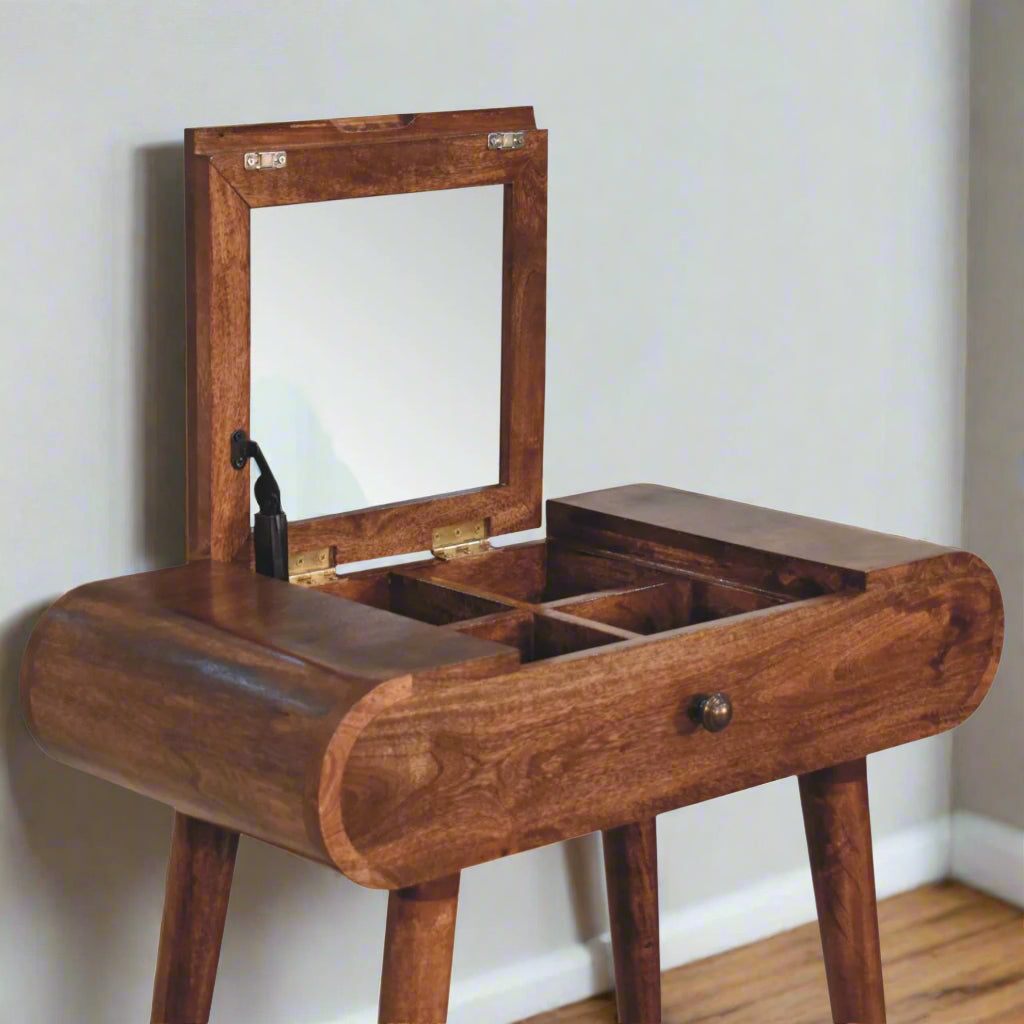 Rounded mini dressing table with honey caramel finish, showcasing open fold-up mirror, revealing storage compartments