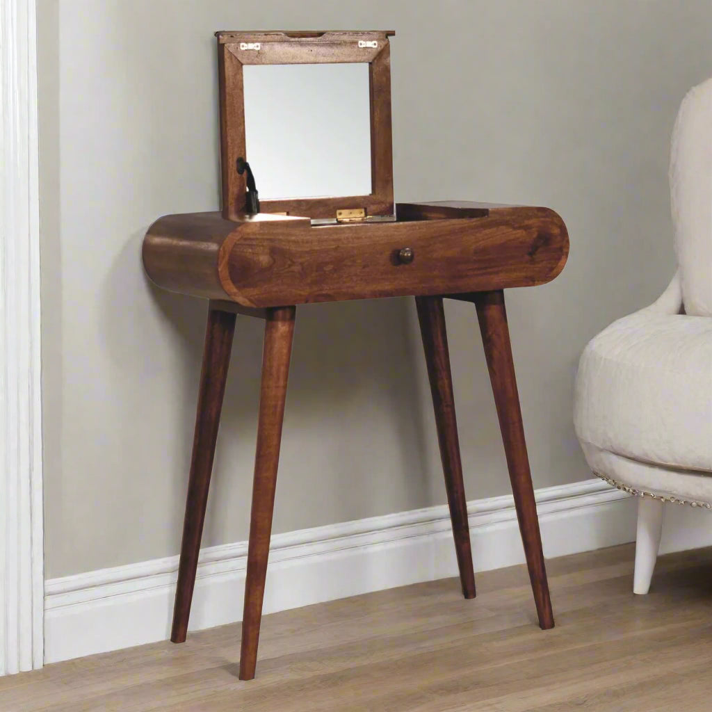 Rounded mini dressing table with honey caramel finish, showcasing front angled view with open fold-up mirror
