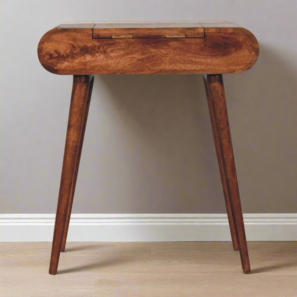 Rounded mini dressing table with honey caramel finish, close up view of back highlighting discreet fold-up mirror hinges
