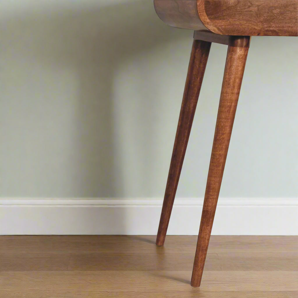 Rounded mini dressing table with honey caramel finish, showcasing close up view of the left side nordic-style-legs