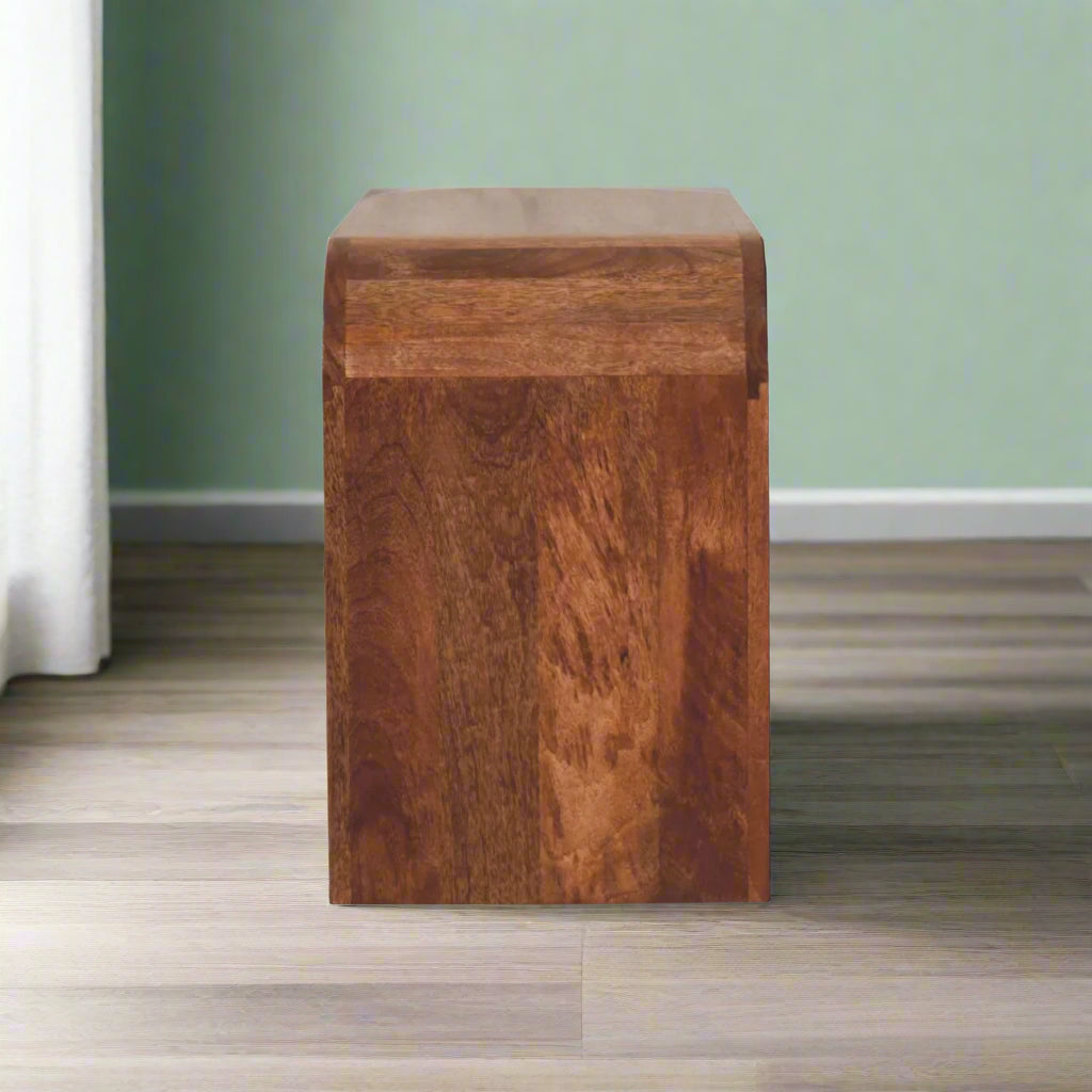 Side view of the Serenity Coffee Table, specifically from the curved edge, emphasizing its unique silhouette.
