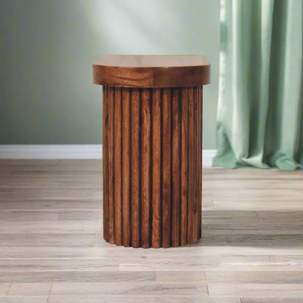 Side view of the Serenity Coffee Table, specifically from the perspective of its cylindrical base, highlighting the ridged edges.