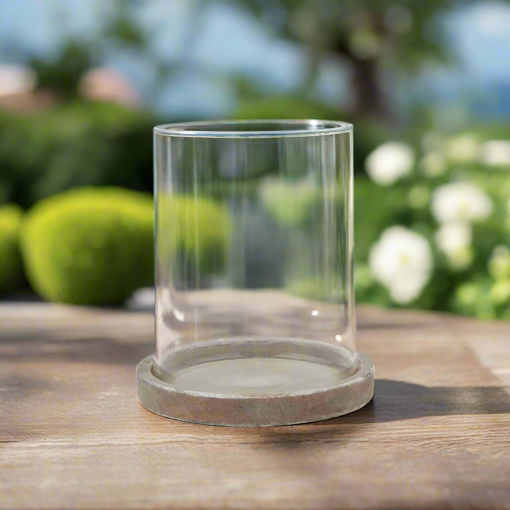 Front view of the compact Siena brown hurricane lantern on an outdoor table.