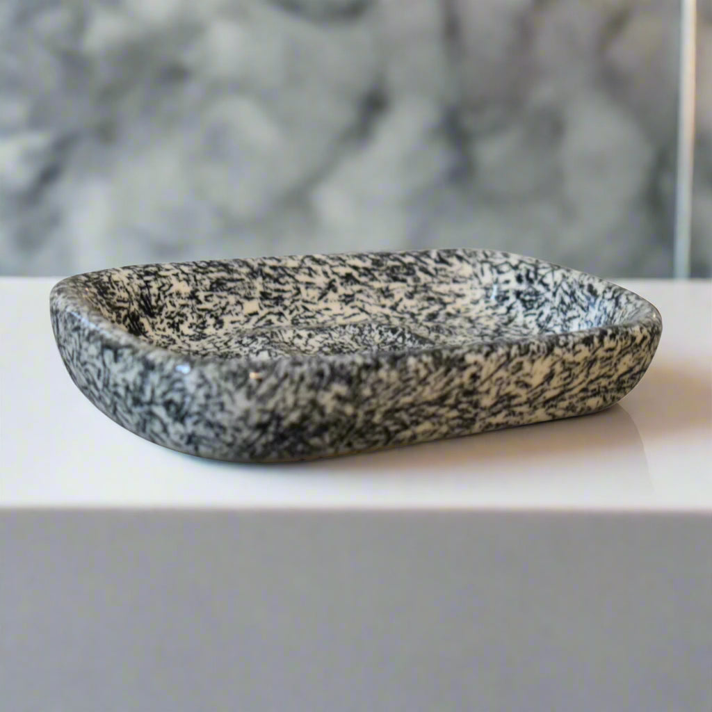 Top-down view of the Daphne bathroom soap dish with smooth porcelain finish and speckled light stone look.