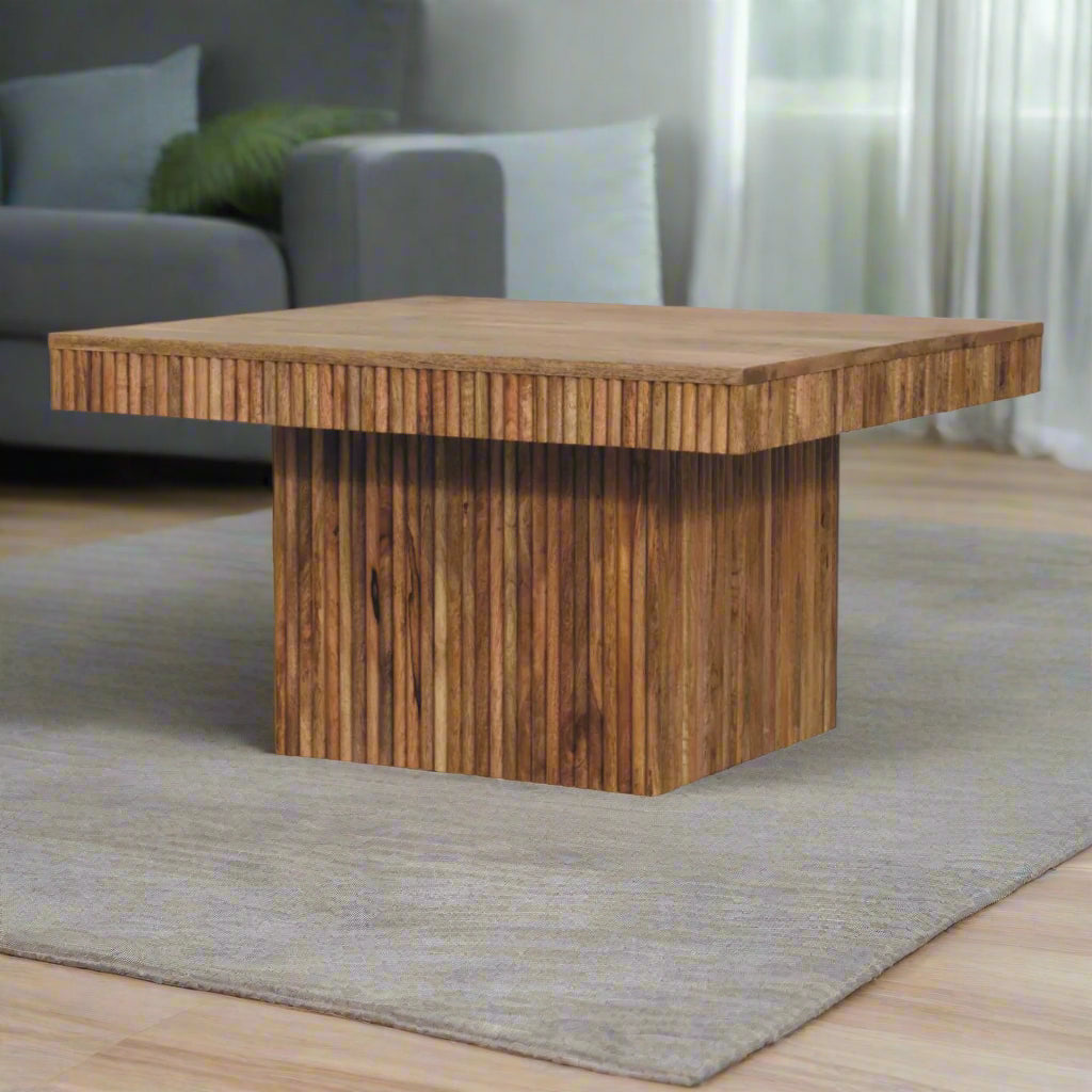 Angled view of the Soba Chunky Coffee Table, stylized on a grey carpet in a modern living room setting.
