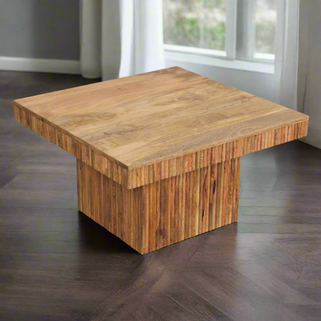 Angled view of the Soba Chunky Coffee Table, showing its upper surface and two sides of its unique ridged base.