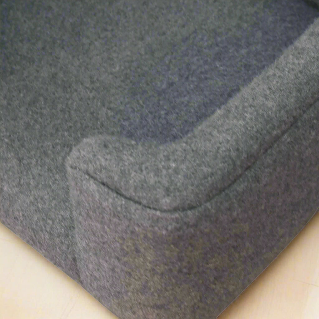 Top-down closeup of the curved left front side of the pet bed showing stitching.
