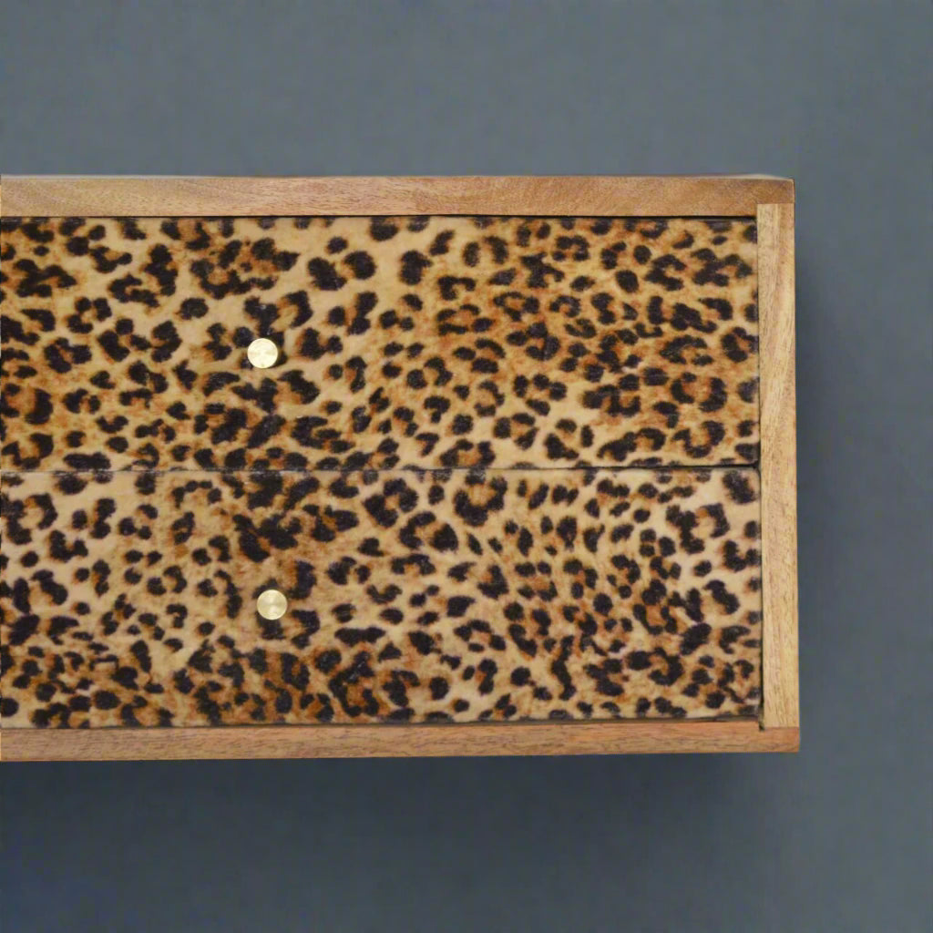 Closer shot of the front of the wall mounted drawer table, highlighting the detailed leopard print and the two drawer knobs.