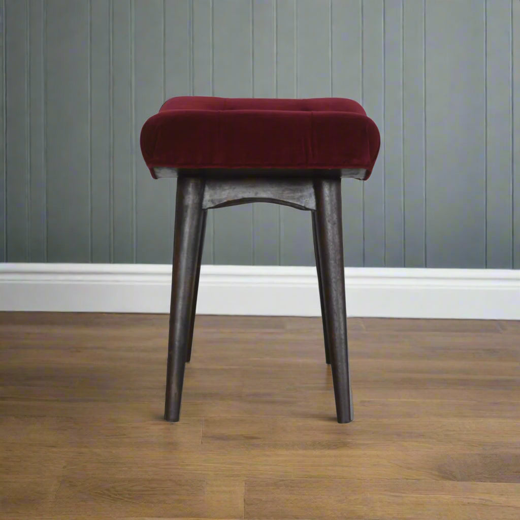 Side view of the Wine Red Velvet Curve Stool, showing its curved silhouette and versatility as a bench or additional seating.