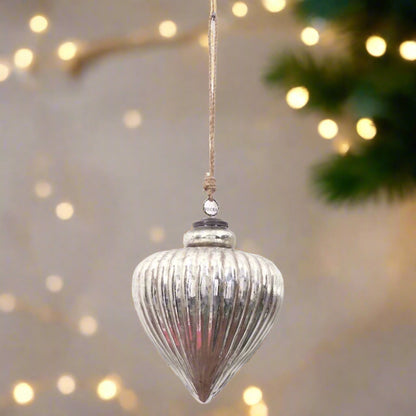 Close-up of a large decorative silver vallupe bauble showing the intricate ribbed pattern and the silver bauble cap and hanging twine. 