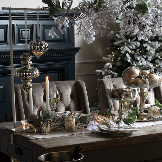 The Large Antique Silver Vallupe Bauble is hanging as a standout piece at a Christmas Dining setting. 
