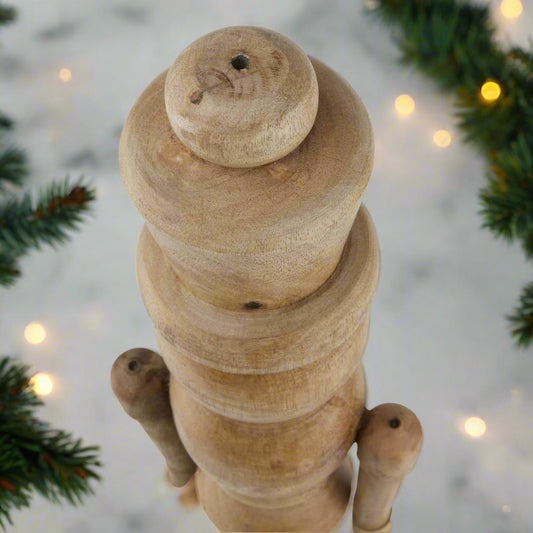 Top view of wooden nutcracker figure showcasing the smooth carve detailing. 